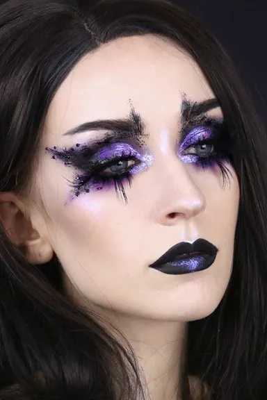 Dark fairy face makeup with bold eyes and mystical Halloween costume details