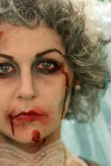 Halloween green zombie special-effects makeup with decayed skin texture and intense eyes
